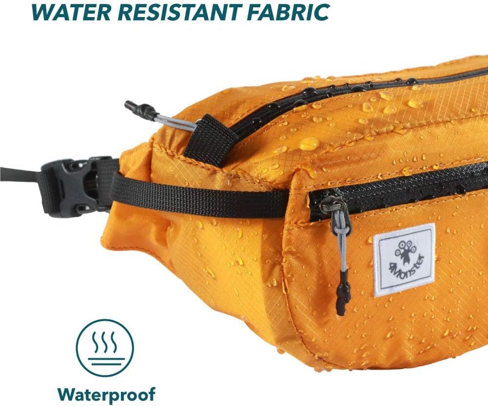 Orange water-resistant hiking waist pack with adjustable strap and zipper compartments showing water droplets on fabric