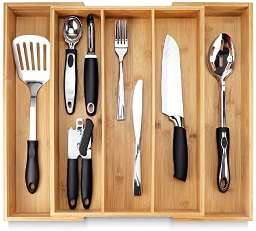 Expandable bamboo silverware tray for drawer organizer with five compartments holding kitchen utensils and cutlery.