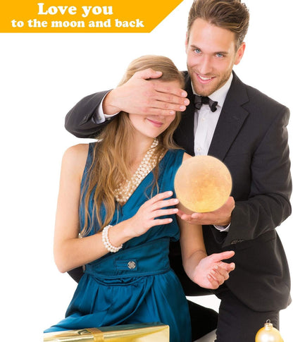 Couple with woman blindfolded holding a 16-color LED 3D printed moon lamp with remote and wooden stand for room decor and gifts